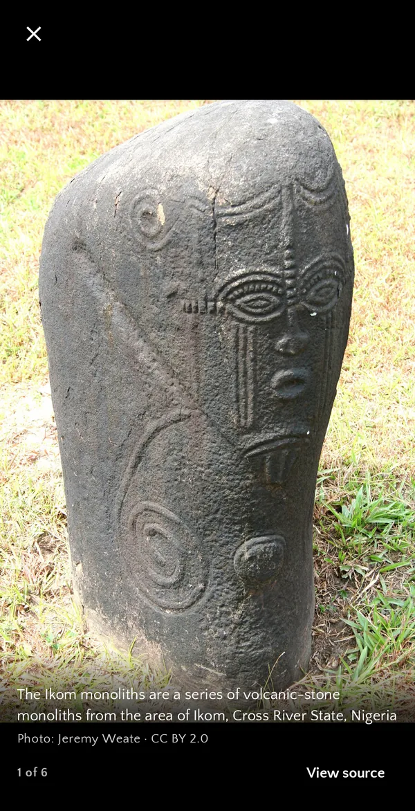 Full-screen photo of an Ikom monolith with its credit